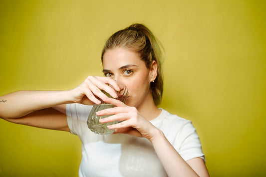 A woman drinking a glass of water