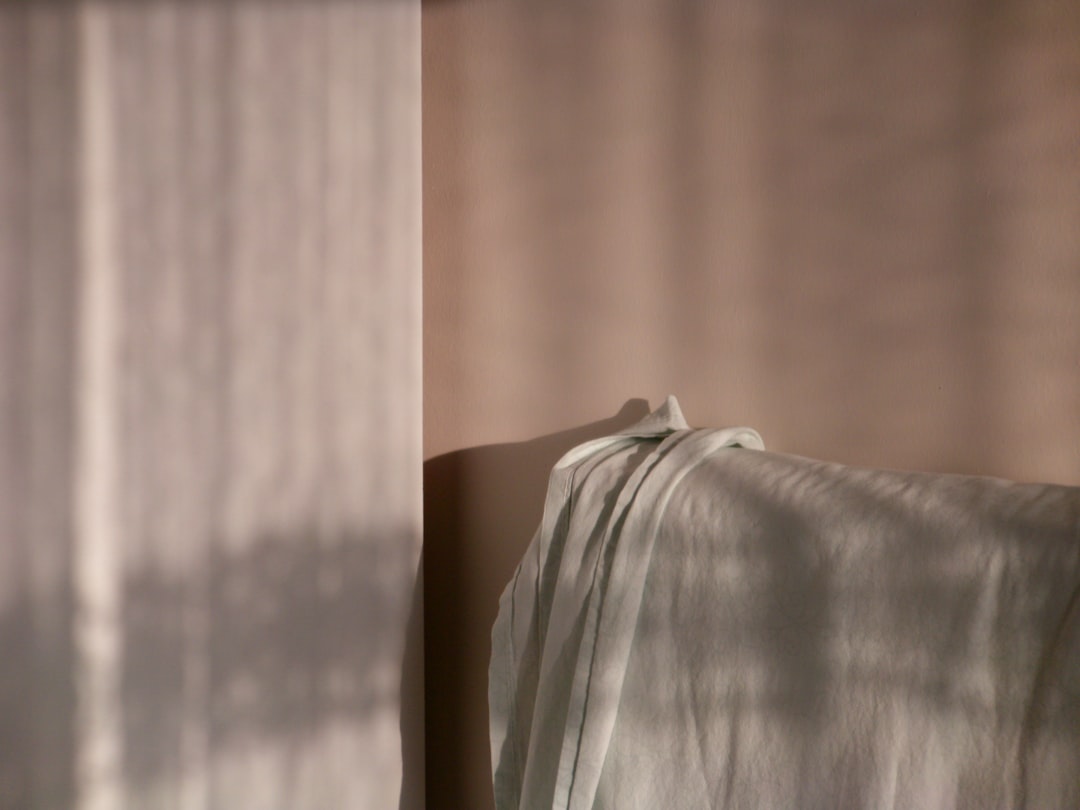Soft fabric draped with dappled light patterns.