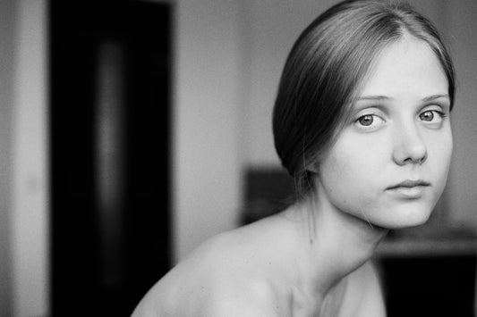 A young woman looks directly at the camera